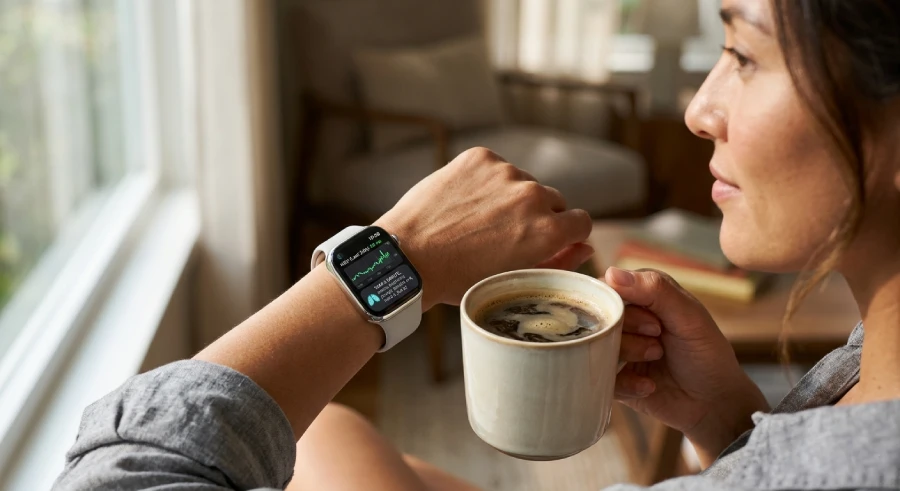 Person wearing a smartwatch showing heart rate variability data connected to an AI mental health app in 2026